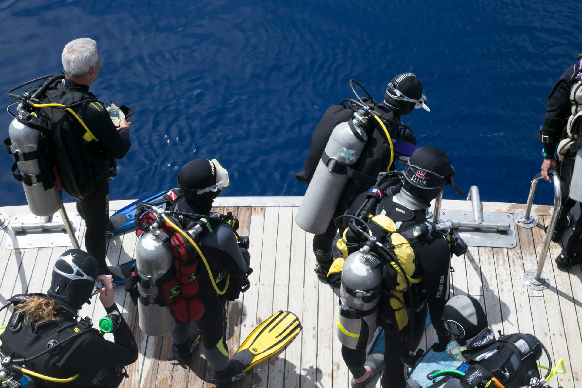 Divers kitting up on the deck of the boat